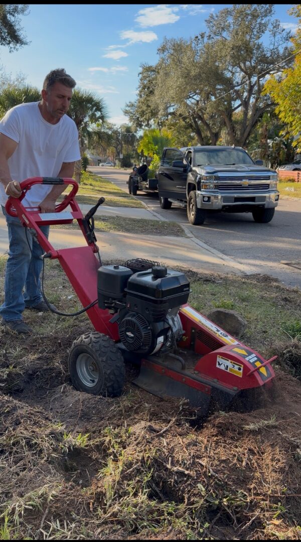 Man operating stump grinder on suburban lawn